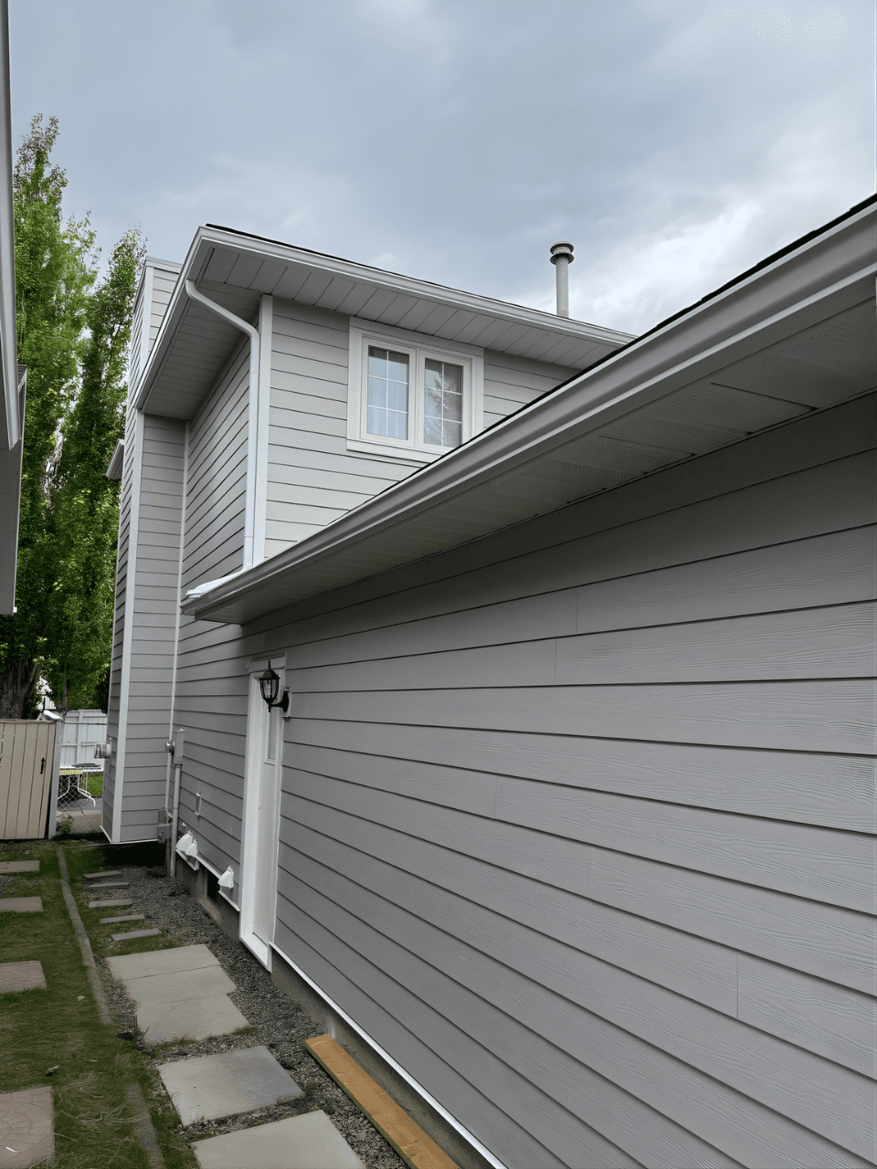 Exterior renovation combining James Hardie siding in Pearl Grey with LP SmartTrim in Arctic White. A balanced, modern color palette paired with durable materials for a sharp, long-lasting finish.