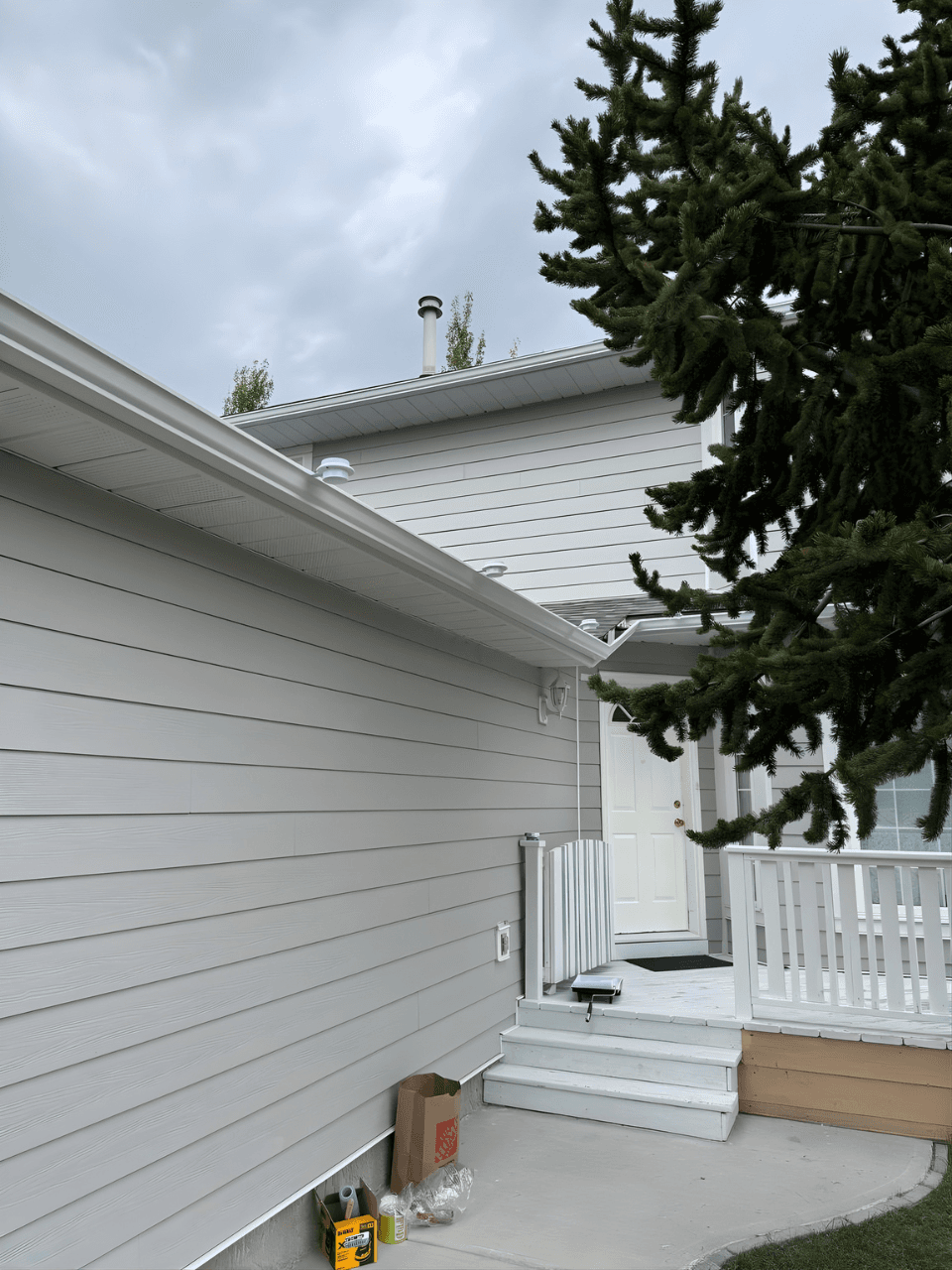 Exterior renovation combining James Hardie siding in Pearl Grey with LP SmartTrim in Arctic White. A balanced, modern color palette paired with durable materials for a sharp, long-lasting finish.