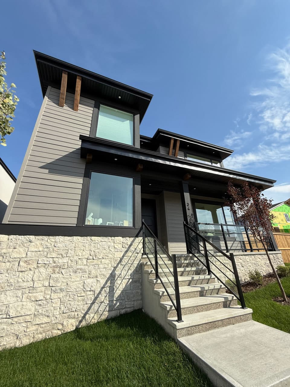 Ground-up exterior installation with a contemporary composition of Hardie panels, board and batten accents, and aluminum roofline details. The palette and textures are selected for clean curb appeal and long-term weather performance.