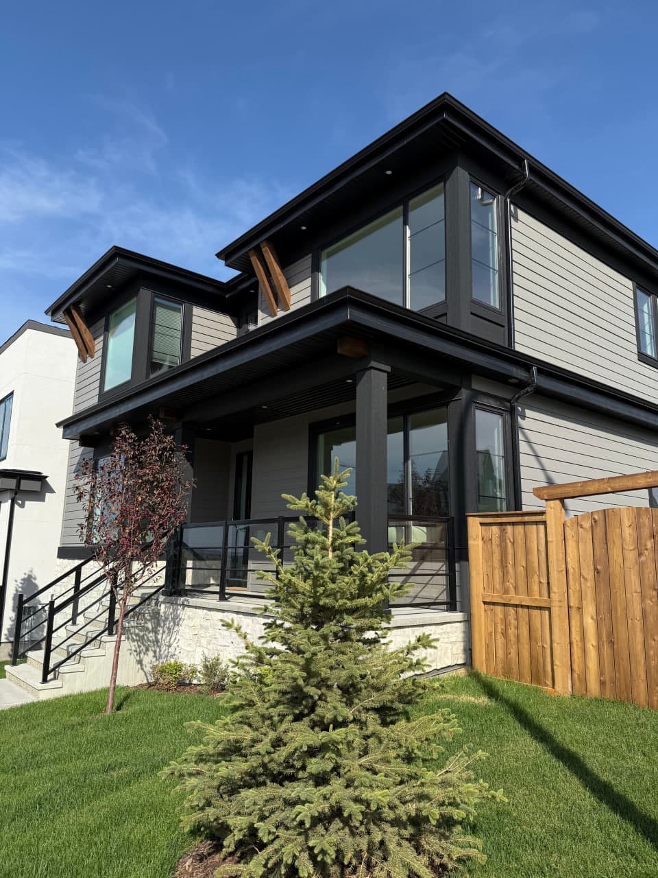 Ground-up exterior installation with a contemporary composition of Hardie panels, board and batten accents, and aluminum roofline details. The palette and textures are selected for clean curb appeal and long-term weather performance.