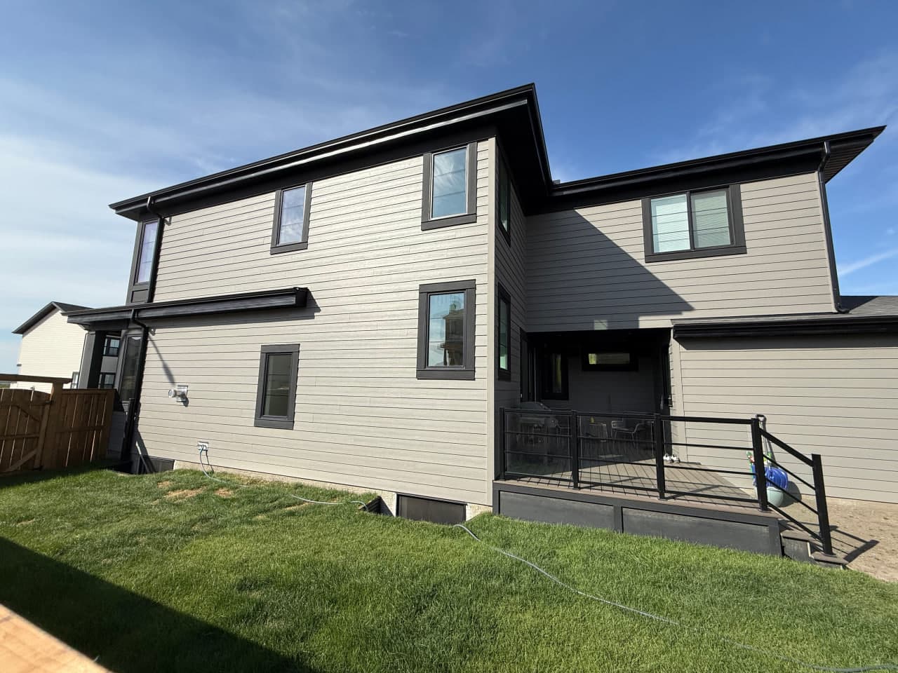 Ground-up exterior installation with a contemporary composition of Hardie panels, board and batten accents, and aluminum roofline details. The palette and textures are selected for clean curb appeal and long-term weather performance.
