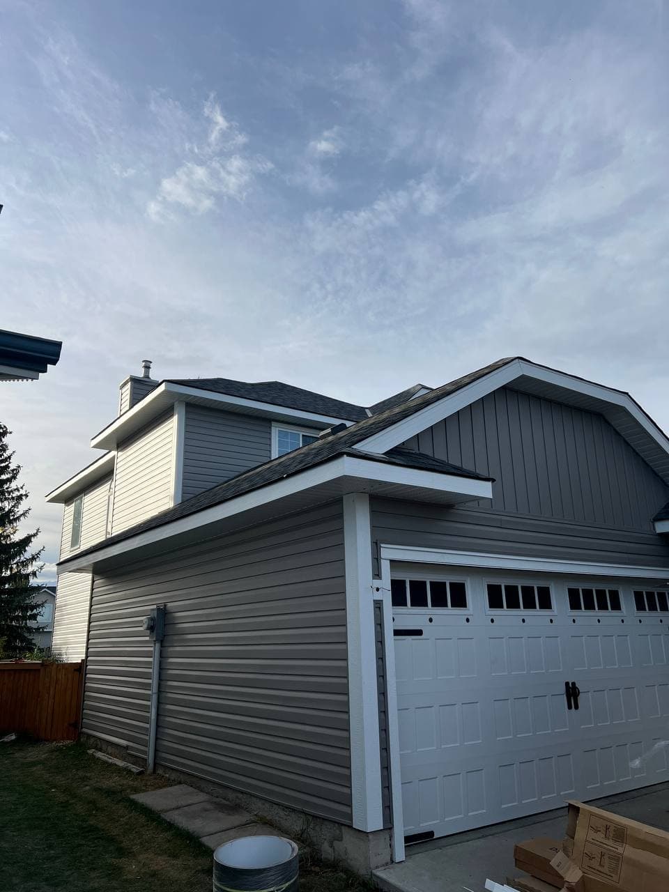 Old vinyl removal and renovation project with new vinyl installation and board-and-batten accent details. The work includes removing the old siding, preparing the surface, and adding clean, modern finishes to improve the look of the house.
