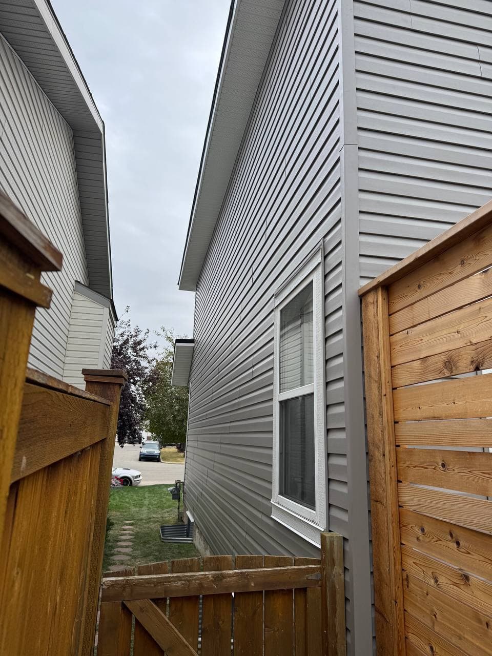 Old vinyl removal and renovation project with new vinyl installation and board-and-batten accent details. The work includes removing the old siding, preparing the surface, and adding clean, modern finishes to improve the look of the house.