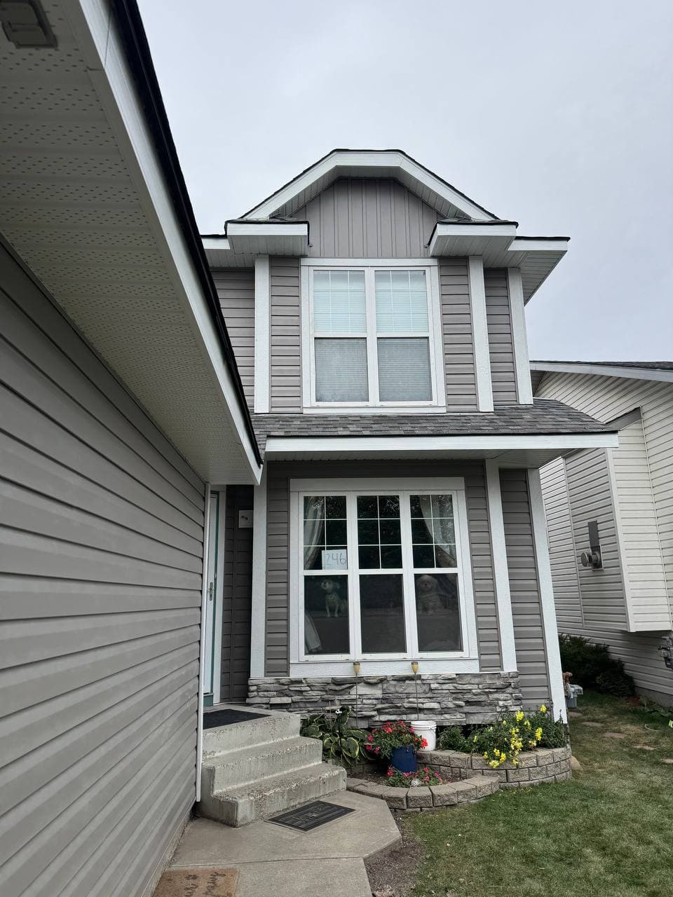 Old vinyl removal and renovation project with new vinyl installation and board-and-batten accent details. The work includes removing the old siding, preparing the surface, and adding clean, modern finishes to improve the look of the house.