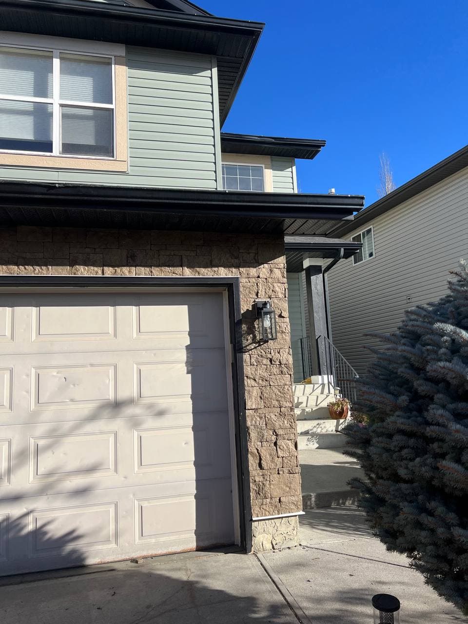 Old vinyl removal and renovation project with new vinyl installation and board-and-batten accent details. The work includes removing the old siding, preparing the surface, and adding clean, modern finishes to improve the look of the house.
