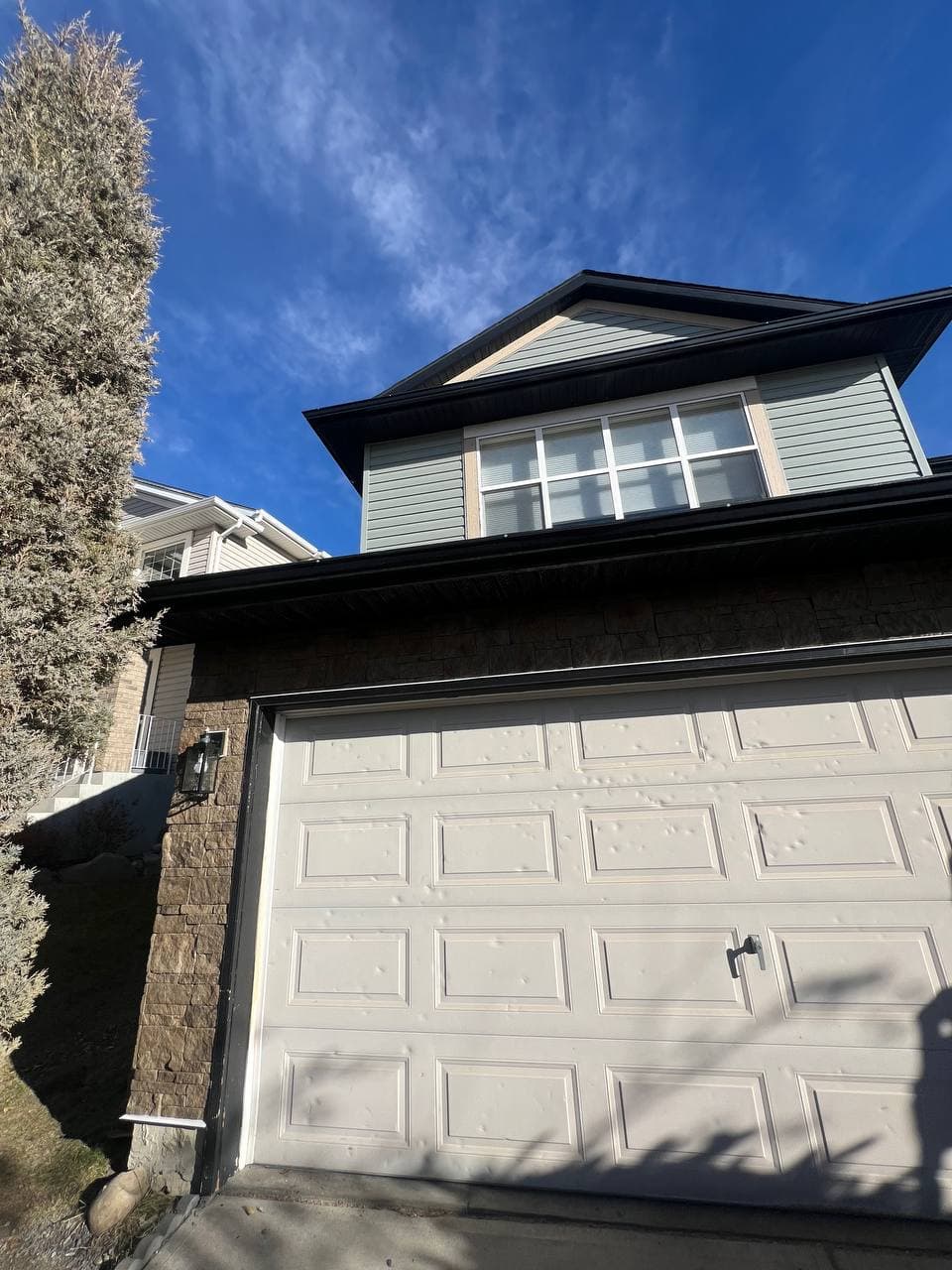 Old vinyl removal and renovation project with new vinyl installation and board-and-batten accent details. The work includes removing the old siding, preparing the surface, and adding clean, modern finishes to improve the look of the house.