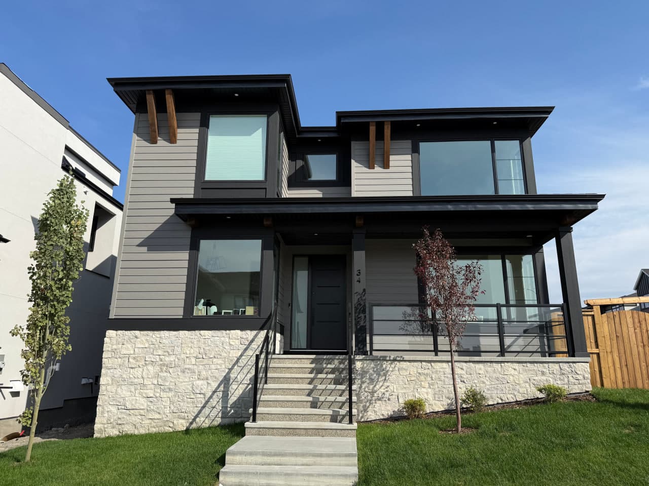 Ground-up exterior installation with a contemporary composition of Hardie panels, board and batten accents, and aluminum roofline details. The palette and textures are selected for clean curb appeal and long-term weather performance.